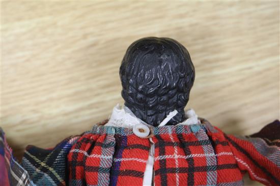 A Victorian doll wearing a tartan dress